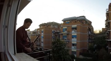 Marco G. Di Marco, guitarrista italiano, tocando na varanda do apartamento durante a quarentena (Foto: Reprodução/YouTube)