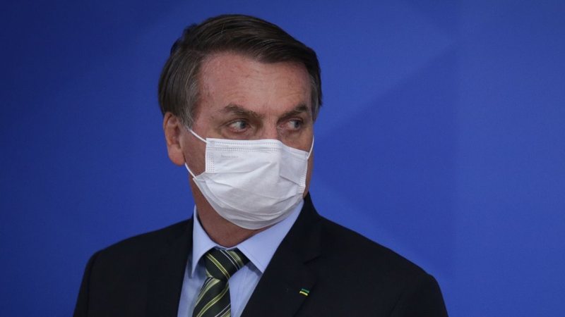 Bolsonaro de máscara olha para o lado (Foto: Andre Coelho/Getty Images)