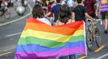 None - Duas mulheres com bandeira LGBTQ+ (Foto: Omer Messinger/Getty Images)